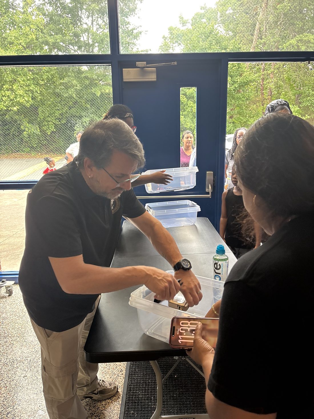 A Hammerhead Security officer assisting a visitor at a check-in table